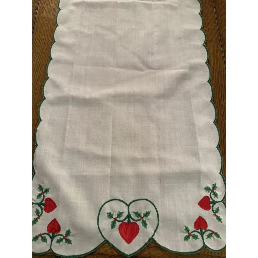 Table runner appliqued with red hearts and embroidered holly leaves 88” X 13.5”